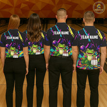 Load image into Gallery viewer, Four people wearing matching shirts with a frog graphic and 'TEAM NAME' text on a bowling alley background.