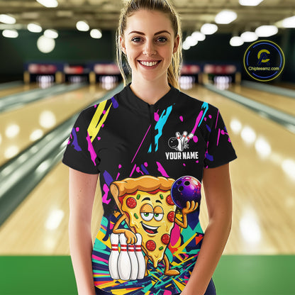 Person wearing a black bowling shirt with colorful design and pizza graphic in a bowling alley.