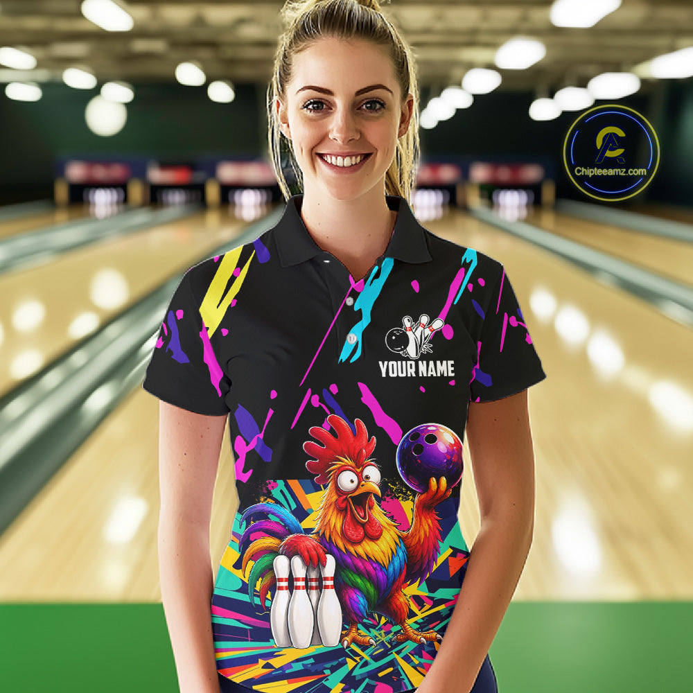 Woman wearing a colorful bowling-themed shirt with a chicken graphic in a bowling alley.