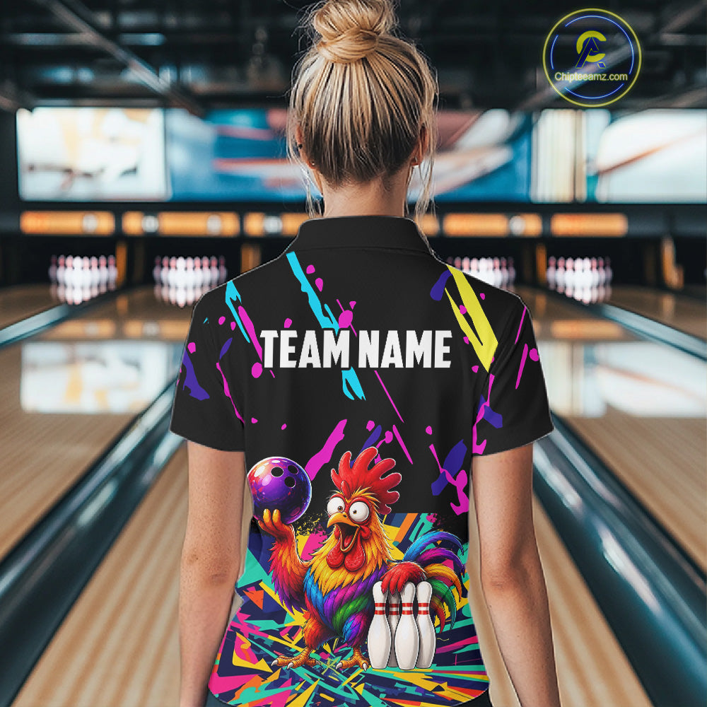 Person wearing a colorful bowling-themed shirt with a chicken design in a bowling alley.