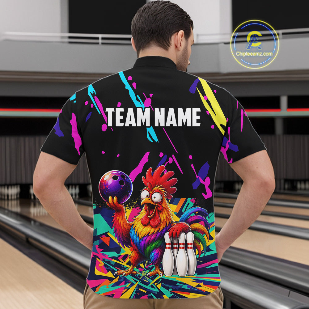 Person wearing a colorful bowling-themed shirt with a rooster design in a bowling alley.