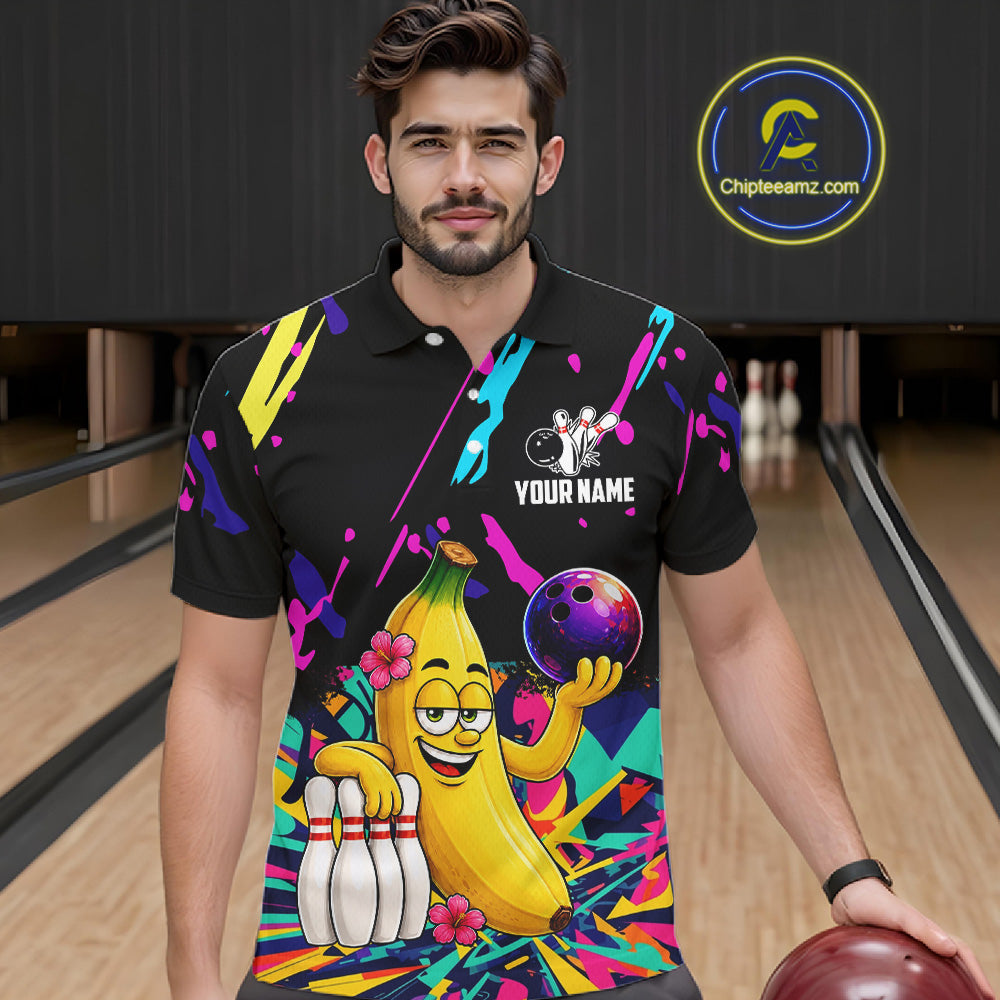 Man wearing a colorful bowling shirt with a cartoon banana character in a bowling alley.