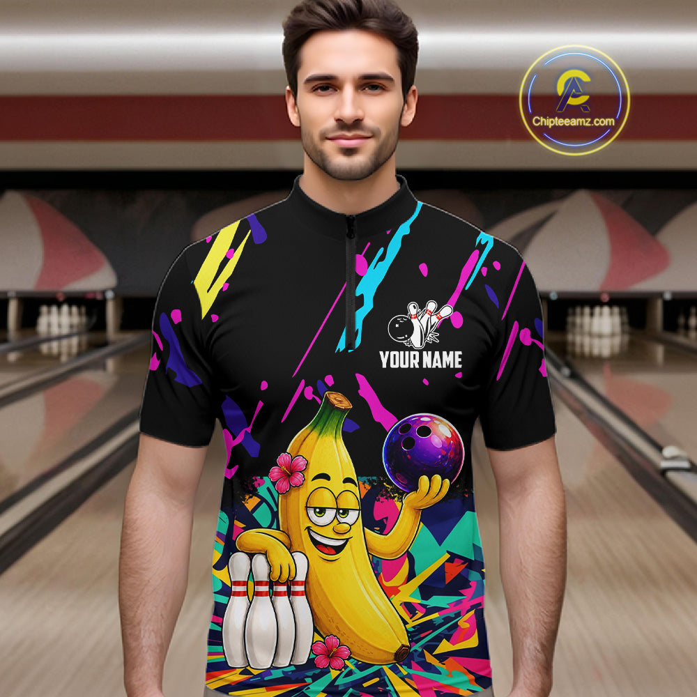 Man wearing a colorful bowling shirt with a cartoon banana character in a bowling alley.
