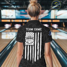 Load image into Gallery viewer, Back view of woman wearing a US flag Texas bowling polo shirt inside a bowling alley.