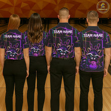 Load image into Gallery viewer, Back view of bowling team wearing matching purple neon raccoon bowling shirts in a bowling alley.