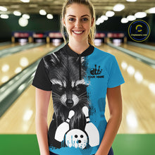 Load image into Gallery viewer, Woman wearing a black and blue raccoon bowling quarter zip jersey during league competition front view.