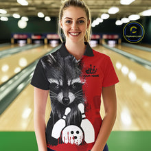 Load image into Gallery viewer, Woman wearing a black and red raccoon bowling polo shirt at a bowling alley front view.