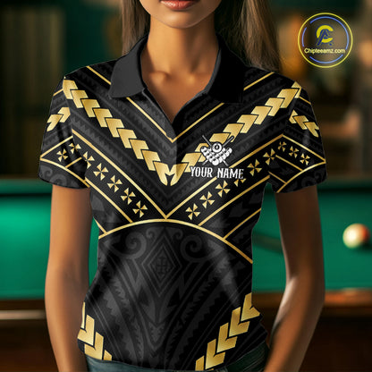 Woman wearing a black and gold 8 ball tribal billiard jersey beside a pool table front view.