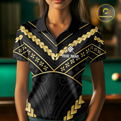 Woman wearing a black and gold 9 ball tribal billiard jersey beside a pool table front view.