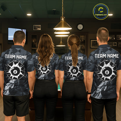 Back view of pool players wearing black and grey billiard shirts in a game room.