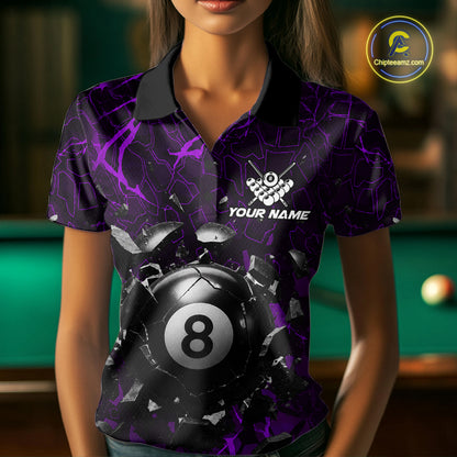 Woman wearing a purple crack 8 ball billiard jersey beside a pool table front view.
