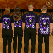 Load image into Gallery viewer, Back view of bowling team wearing matching purple eagle bowling shirts in a bowling alley.