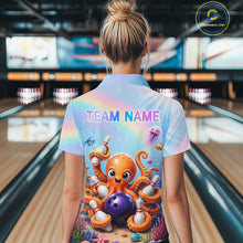 Load image into Gallery viewer, Back view of woman wearing a rainbow octopus ocean bowling polo shirt inside a bowling alley.