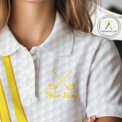 White polo shirt with yellow stripes and embroidered golf clubs and text on a blurred background
