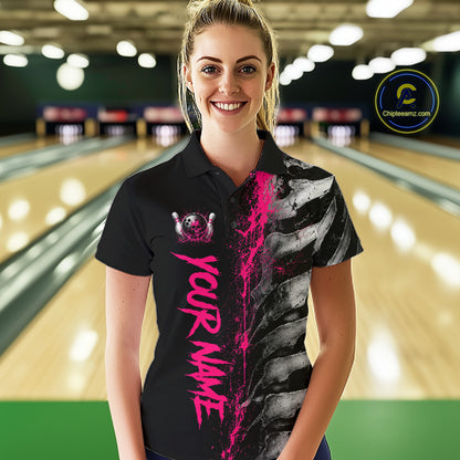 Female model wearing Pink Splatter Grey Bone bowling polo shirt during league tournament, personalized bowling apparel, skeleton graphic, athletic confidence, breast cancer awareness support