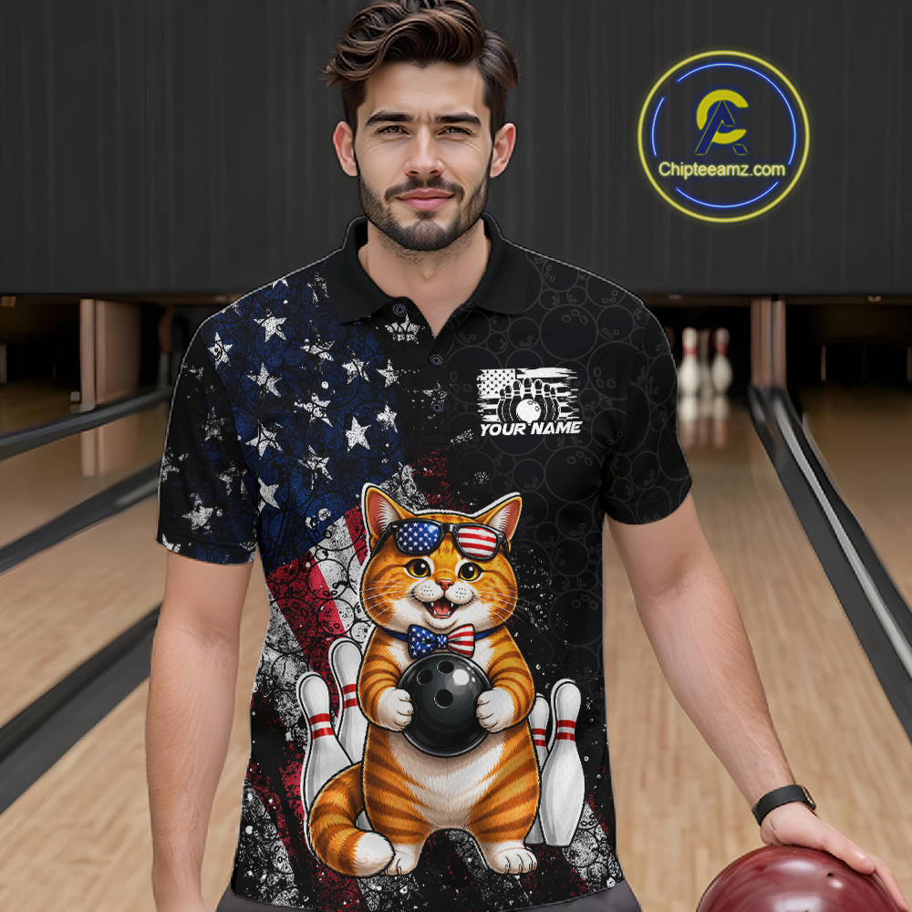 Man wearing a black polo shirt with a cat bowling design in a bowling alley.